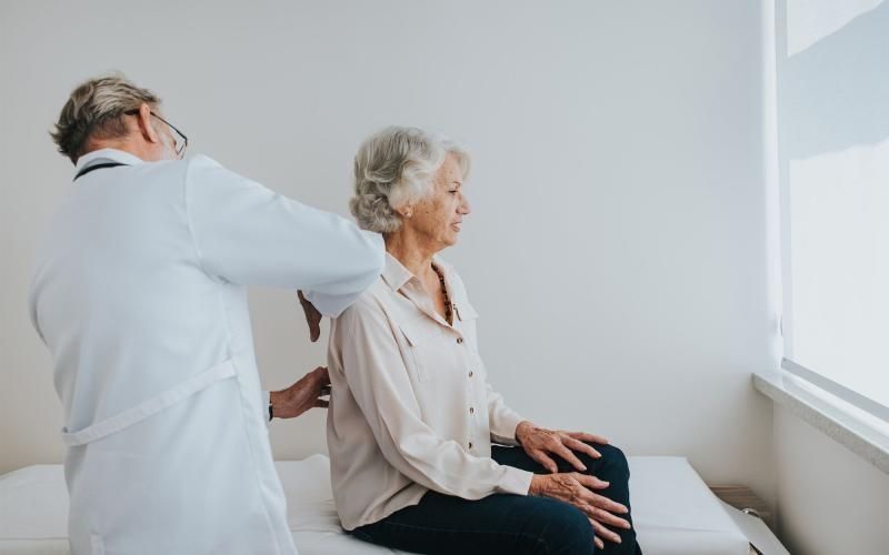 a doctor checking on an older woman